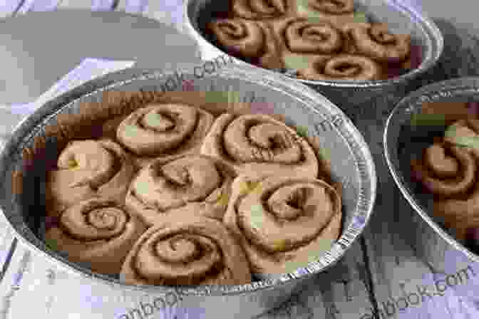 A Basket Filled With Freshly Baked Cinnamon Buns, Their Golden Crusts Glistening With Cinnamon Sugar. One Tin Bakes: Sweet And Simple Traybakes Pies Bars And Buns