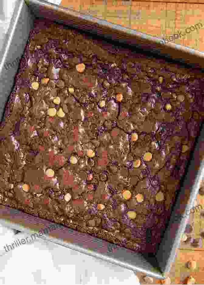 A Golden Tray Of Freshly Baked Brownies Adorned With Chocolate Chips And Sprinkled With Powdered Sugar. One Tin Bakes: Sweet And Simple Traybakes Pies Bars And Buns